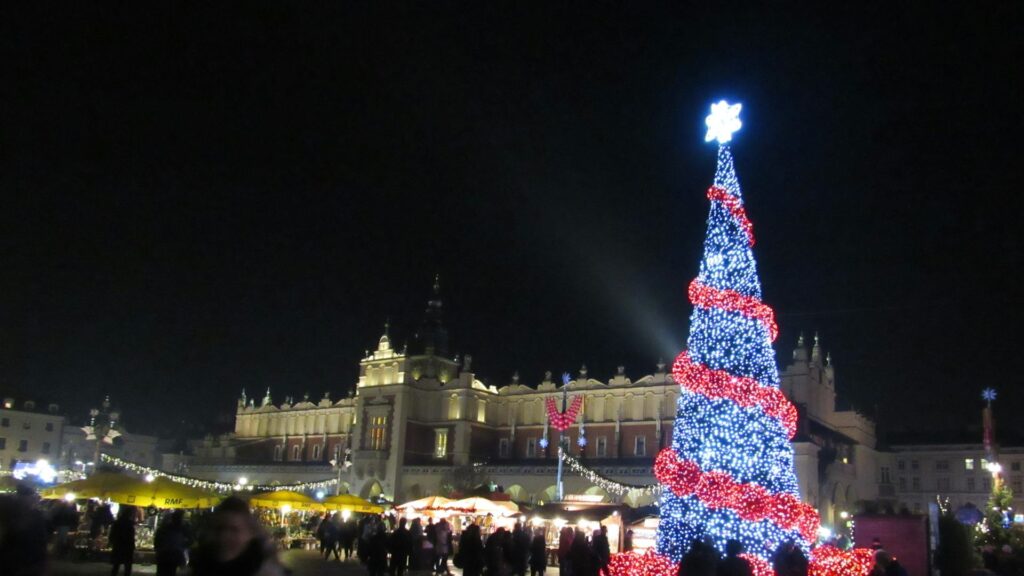 Christmas tree and Christmas market in front of the Cloth Hall on Krakow's Main Square at night